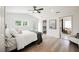 Bright bedroom features wood floors, a ceiling fan, and a view to the backyard at 5840 N El Capitan Way, Las Vegas, NV 89149