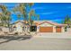 Charming front exterior with a well-manicured lawn, a tile roof, and a welcoming double-door garage at 5840 N El Capitan Way, Las Vegas, NV 89149