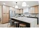 Modern kitchen with stainless steel appliances, a large island, and stylish pendant lighting above the island at 5840 N El Capitan Way, Las Vegas, NV 89149