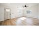 Bright living room features new floors, a modern ceiling fan, and natural light from two windows at 5840 N El Capitan Way, Las Vegas, NV 89149