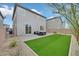 Private backyard featuring patio, artificial grass, and modern outdoor furniture at 6130 Yuzu Pl, Las Vegas, NV 89122