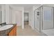 Bathroom showcasing a glass-enclosed shower and single sink with tile flooring at 6130 Yuzu Pl, Las Vegas, NV 89122