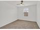 Bedroom with neutral carpet, a ceiling fan, and a window offering neighborhood views at 6130 Yuzu Pl, Las Vegas, NV 89122