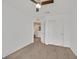 Neutral bedroom offering an open doorway and closet with sliding doors at 6130 Yuzu Pl, Las Vegas, NV 89122
