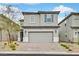 Charming two-story home featuring a two-car garage, neutral tones, and a beautifully landscaped front yard at 6130 Yuzu Pl, Las Vegas, NV 89122
