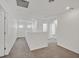 Upstairs hallway with neutral carpet, fresh paint, and natural light coming in from the windows at 6130 Yuzu Pl, Las Vegas, NV 89122