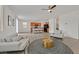 Open-concept living room showing the kitchen area, tile flooring, ceiling fan, and lots of natural light at 6130 Yuzu Pl, Las Vegas, NV 89122