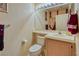 Powder room featuring a toilet, a vanity with a mirror, and attractive decor at 653 Mountain Rdg, Mesquite, NV 89027
