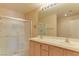 Bathroom featuring a glass-enclosed shower and double sink vanity at 653 Mountain Rdg, Mesquite, NV 89027