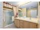 Bathroom with a dual sink vanity, a large mirror and an enclosed shower at 653 Mountain Rdg, Mesquite, NV 89027