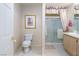 Bathroom with a toilet, a mirror, a sink, and an enclosed shower at 653 Mountain Rdg, Mesquite, NV 89027