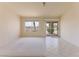 Bright bedroom featuring a sliding glass door to the patio and neutral carpet and tile at 653 Mountain Rdg, Mesquite, NV 89027