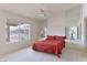 Bright bedroom featuring a ceiling fan, large window with pool view, and mirrored accents at 653 Mountain Rdg, Mesquite, NV 89027