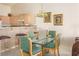 Cozy dining area with glass table, seating for four, and adjacent breakfast bar off kitchen at 653 Mountain Rdg, Mesquite, NV 89027