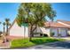 Attractive property with a tile roof, green lawn, mature tree, and single-car garage at 653 Mountain Rdg, Mesquite, NV 89027