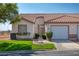 Charming single-story home featuring a tile roof, well-manicured lawn, and a one-car garage at 653 Mountain Rdg, Mesquite, NV 89027