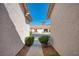 View between houses leading to a charming home with a well-manicured lawn and garage at 653 Mountain Rdg, Mesquite, NV 89027