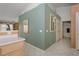 Hallway featuring green accent wall, tile floors, and leads to a variety of rooms at 653 Mountain Rdg, Mesquite, NV 89027