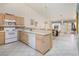 Functional kitchen featuring white appliances, light wood cabinets, and a breakfast bar at 653 Mountain Rdg, Mesquite, NV 89027
