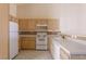 Functional kitchen with white appliances, ample cabinetry, and tile flooring for easy cleaning at 653 Mountain Rdg, Mesquite, NV 89027