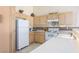 Efficient kitchen with ample counter space, white appliances, and light wood cabinetry at 653 Mountain Rdg, Mesquite, NV 89027