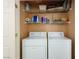 Convenient laundry closet equipped with a washer, dryer, and shelving for supplies at 653 Mountain Rdg, Mesquite, NV 89027