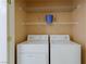 A functional laundry room with a washer, dryer, and shelving at 653 Mountain Rdg, Mesquite, NV 89027