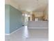 Open-concept living space with breakfast bar connecting to kitchen, light walls and tile flooring at 653 Mountain Rdg, Mesquite, NV 89027