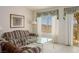 Comfortable living room space featuring neutral walls, patterned sofas, and a glass top coffee table at 653 Mountain Rdg, Mesquite, NV 89027