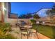 Cozy backyard featuring a barbecue grill, comfortable seating, and artificial turf for low maintenance at 6546 American Flower St, Las Vegas, NV 89148