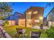 Expansive backyard featuring lounge chairs, BBQ grill, well-maintained lawn, and a covered patio at 6546 American Flower St, Las Vegas, NV 89148