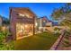 Inviting backyard with artificial grass, covered patio, outdoor furniture, and landscaped borders at 6546 American Flower St, Las Vegas, NV 89148