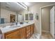 Bathroom features double sinks with wooden cabinetry and tile flooring at 6546 American Flower St, Las Vegas, NV 89148
