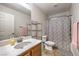 Well-lit bathroom with a large mirror, vanity with marble countertop, and a shower with a decorative curtain at 6546 American Flower St, Las Vegas, NV 89148