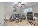 Bedroom with a gray sofa, work desk, and neutral decor at 6546 American Flower St, Las Vegas, NV 89148