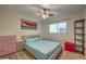 Cozy bedroom with wood floors, a ceiling fan, and bright, cheerful colors at 6546 American Flower St, Las Vegas, NV 89148