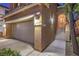 Inviting exterior of a home featuring a two-car garage, manicured landscaping, and a charming entrance with a decorative security door at 6546 American Flower St, Las Vegas, NV 89148
