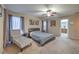 Bright main bedroom with a cozy seating area, plush carpet, and natural light at 6546 American Flower St, Las Vegas, NV 89148