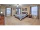 Large main bedroom with neutral walls and carpet, featuring a seating area and plenty of room at 6546 American Flower St, Las Vegas, NV 89148
