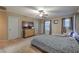 Serene main bedroom with a ceiling fan, TV, and windows that let in natural light at 6546 American Flower St, Las Vegas, NV 89148