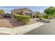 Well-manicured front yard and driveway of this house leading up to the three-car garage at 7340 Orchard Harvest Ave, Las Vegas, NV 89131