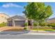 Charming single-story home featuring a three-car garage and professionally landscaped front yard with mature trees at 7340 Orchard Harvest Ave, Las Vegas, NV 89131