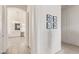Hallway featuring wall decor that leads to the main bathroom that features double vanity and a chandelier at 7340 Orchard Harvest Ave, Las Vegas, NV 89131