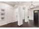 Hallway features modern lighting, decorative columns, and dark hardwood floors at 7340 Orchard Harvest Ave, Las Vegas, NV 89131