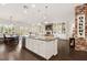 Open kitchen with white cabinets, granite counters, large island, and stainless steel appliances at 7340 Orchard Harvest Ave, Las Vegas, NV 89131