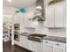 Modern kitchen showcasing stainless steel appliances, white cabinets, and granite countertops at 7340 Orchard Harvest Ave, Las Vegas, NV 89131