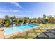 Inviting backyard pool featuring unique brick and turf decking under a clear blue sky at 7340 Orchard Harvest Ave, Las Vegas, NV 89131