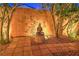 Tranquil backyard featuring a Buddha statue, mature trees, and decorative gravel at 7521 Dry Pines Cir, Las Vegas, NV 89129