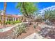 Lush backyard featuring mature trees, desert plants, and charming stone pathways at 7521 Dry Pines Cir, Las Vegas, NV 89129