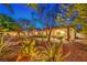 Lush backyard featuring a stone patio with outdoor seating, perfect for enjoying the serene and private outdoor space at 7521 Dry Pines Cir, Las Vegas, NV 89129